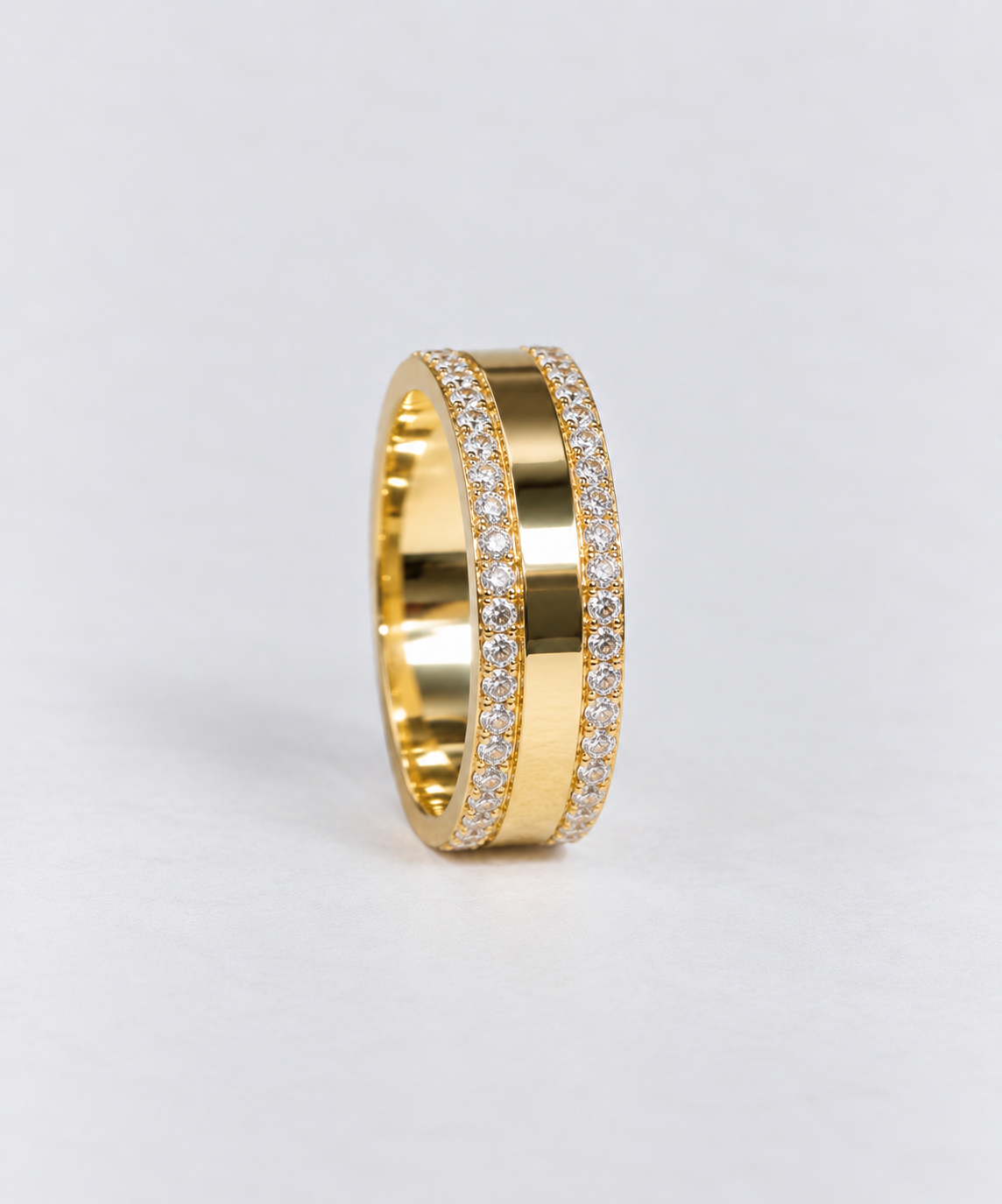 a 9ct yellow gold cigar band with round brilliant cut diamonds set on both edges