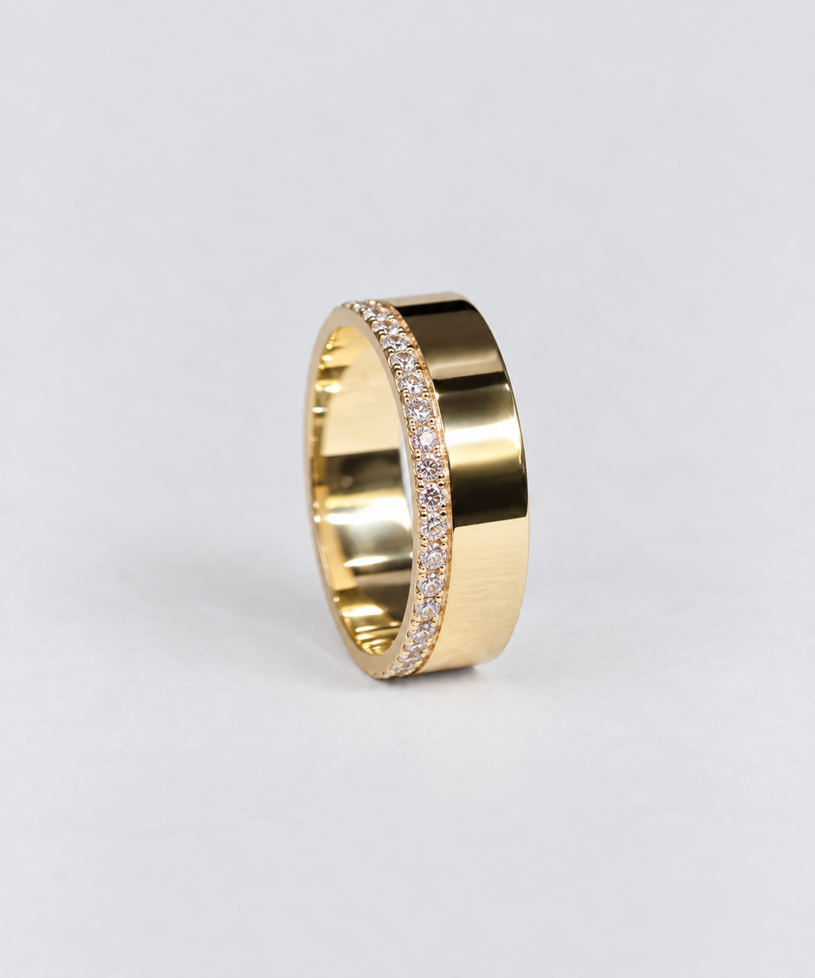 a 9ct yellow gold cigar band with diamonds set on the edge