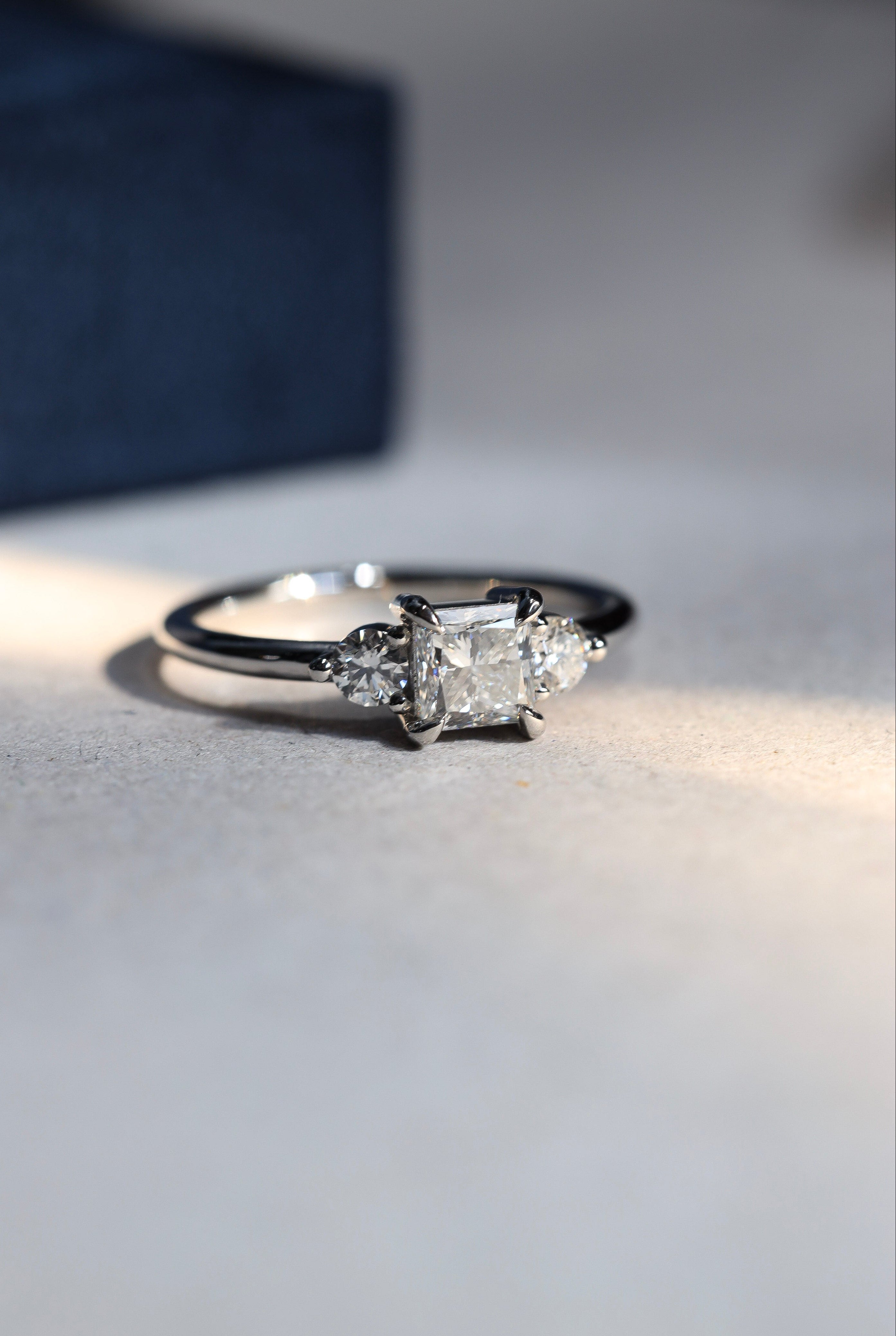 platinum trilogy ring with princess and round brilliant cut diamonds 